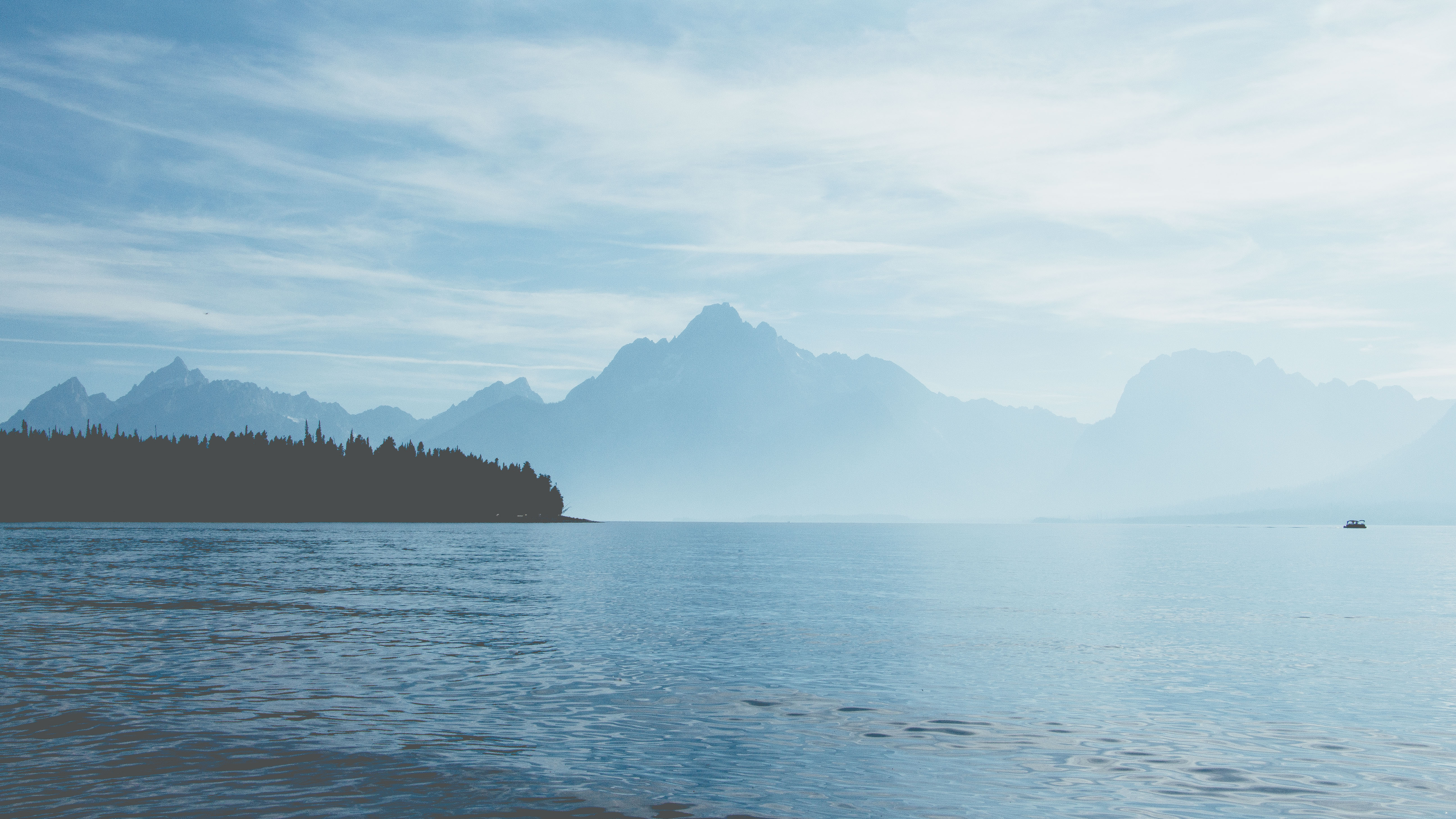 Mountain peaks reflected in a still alpine lake